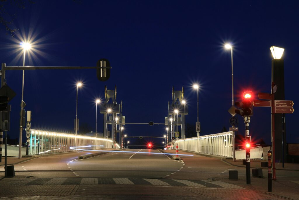 pexels-photo-416954-416954 A modern bridge with street lights and light trails against a dark evening sky.